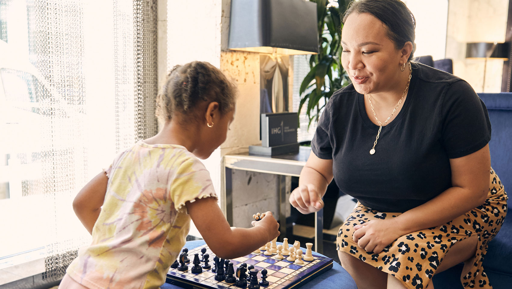 Mom and daughter playing chess