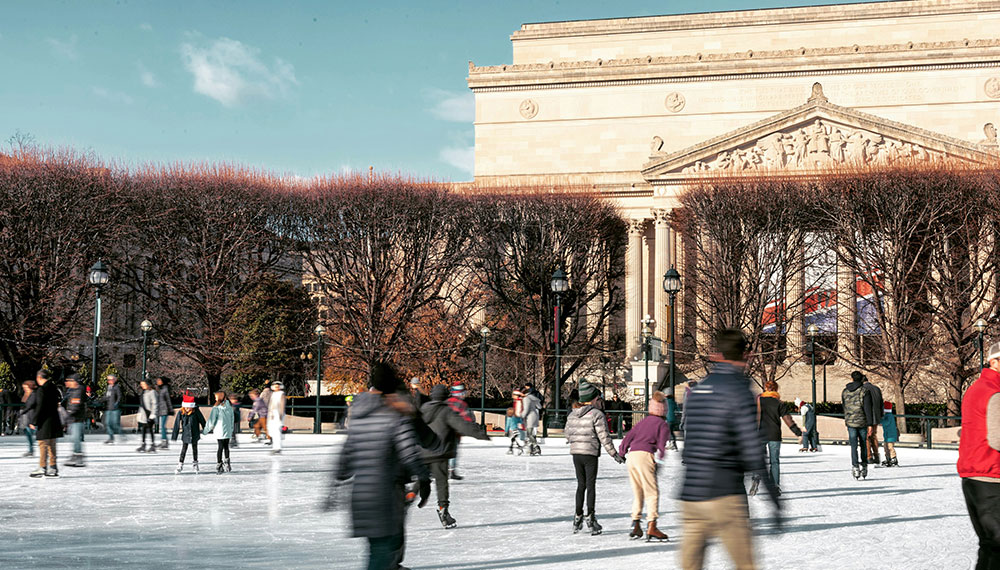 people ice skating in front of the national gallery of art