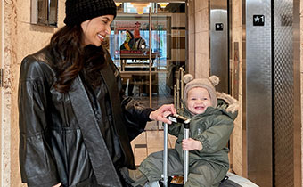 mom and child with suitcase in Hotel George lobby